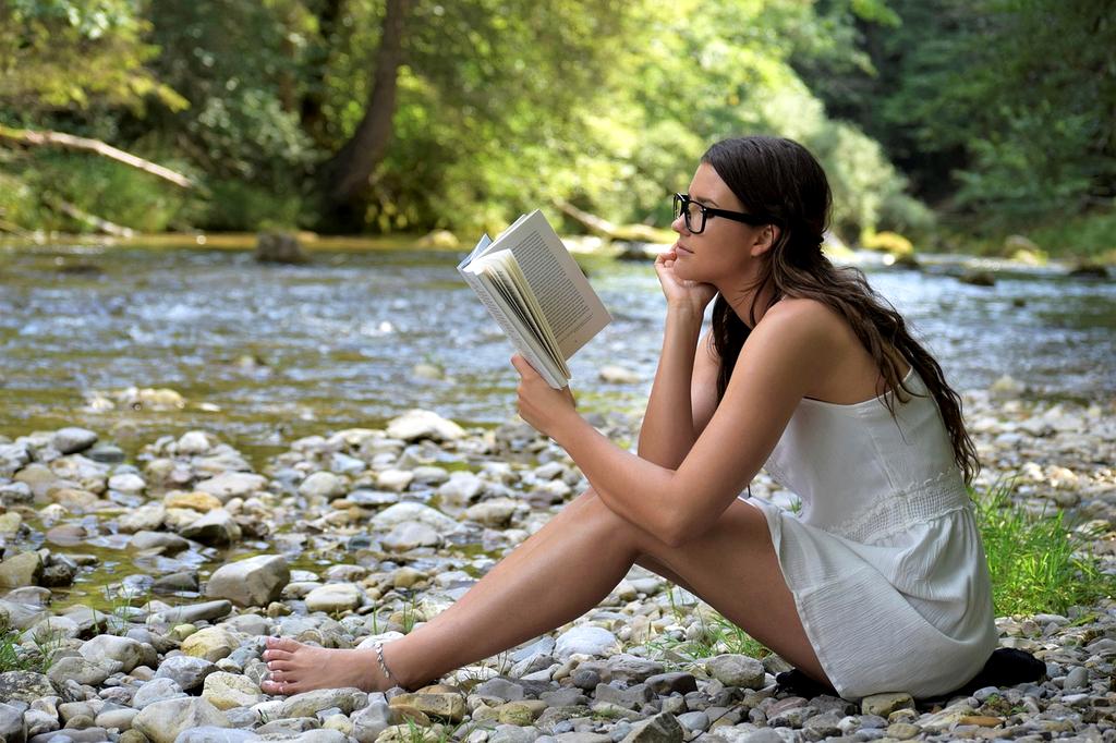 Woman meditating in nature to illustrate mindfulness in lifestyle planning